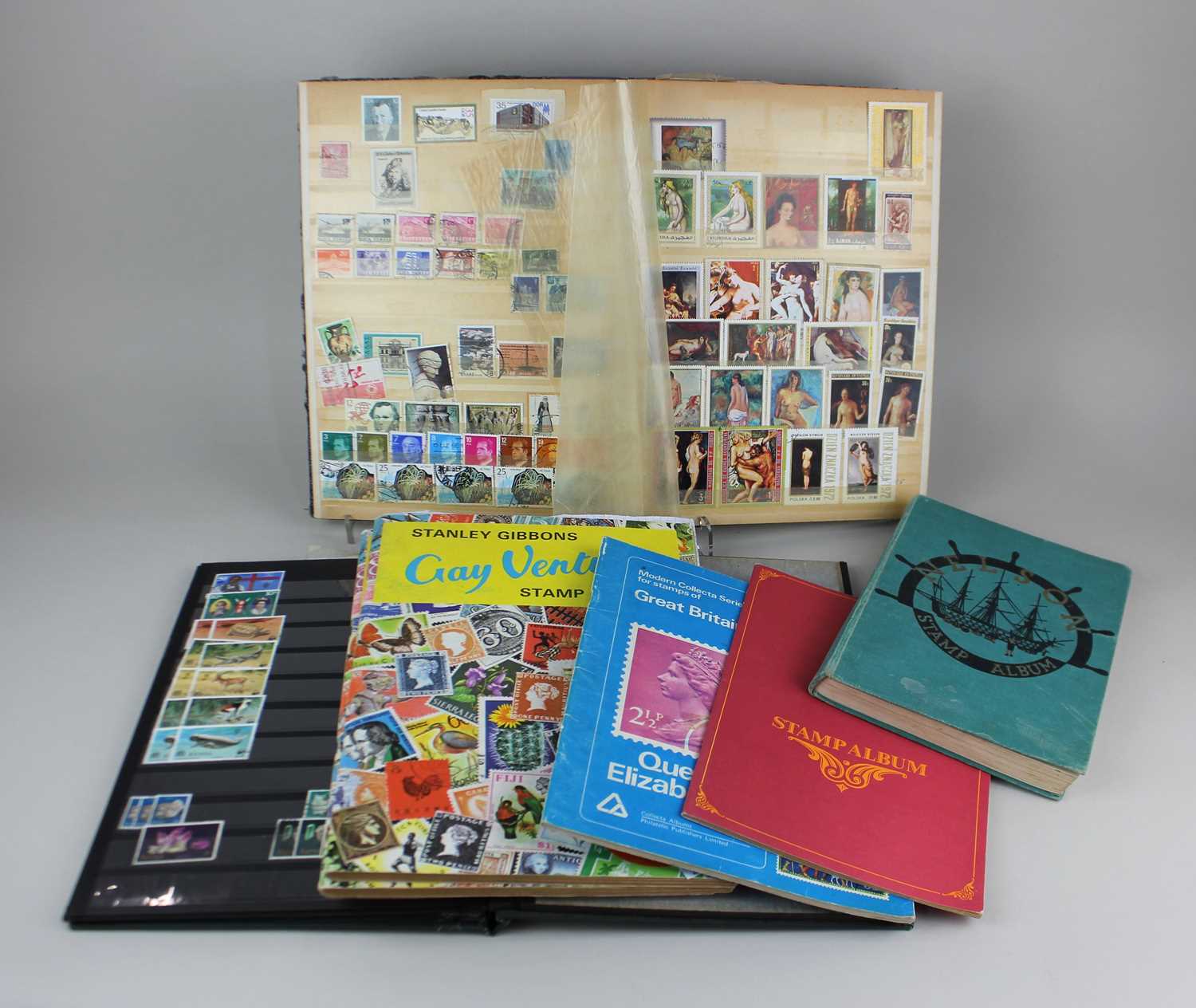 Seven albums of British and World stamps to include the Nelson Stamp Album and Stanley Gibbons Gay