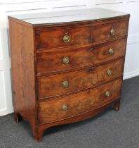 A George III mahogany bowfront chest of two short over three long drawers with drop ring handles, on