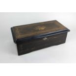 A small Swiss music box with 6 inch brass cylinder in inlaid rosewood case (a/f side panel