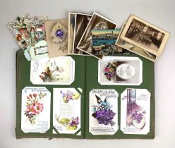 A collection of early 20th century and later postcards and greetings cards to include an album, most