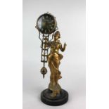 An Art Nouveau style figurine clock with gilt spelter figure of Diana holding aloft swinging