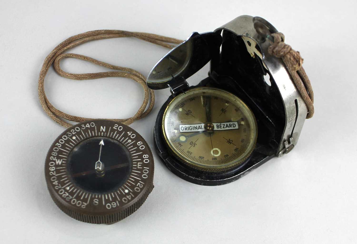 A US Army Corps of Engineers military compass and an Original Bezard compass