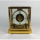 A Le Coultre Atmos mantle clock glazed gilt metal framed case with 'flip down' front panel, c.1970'