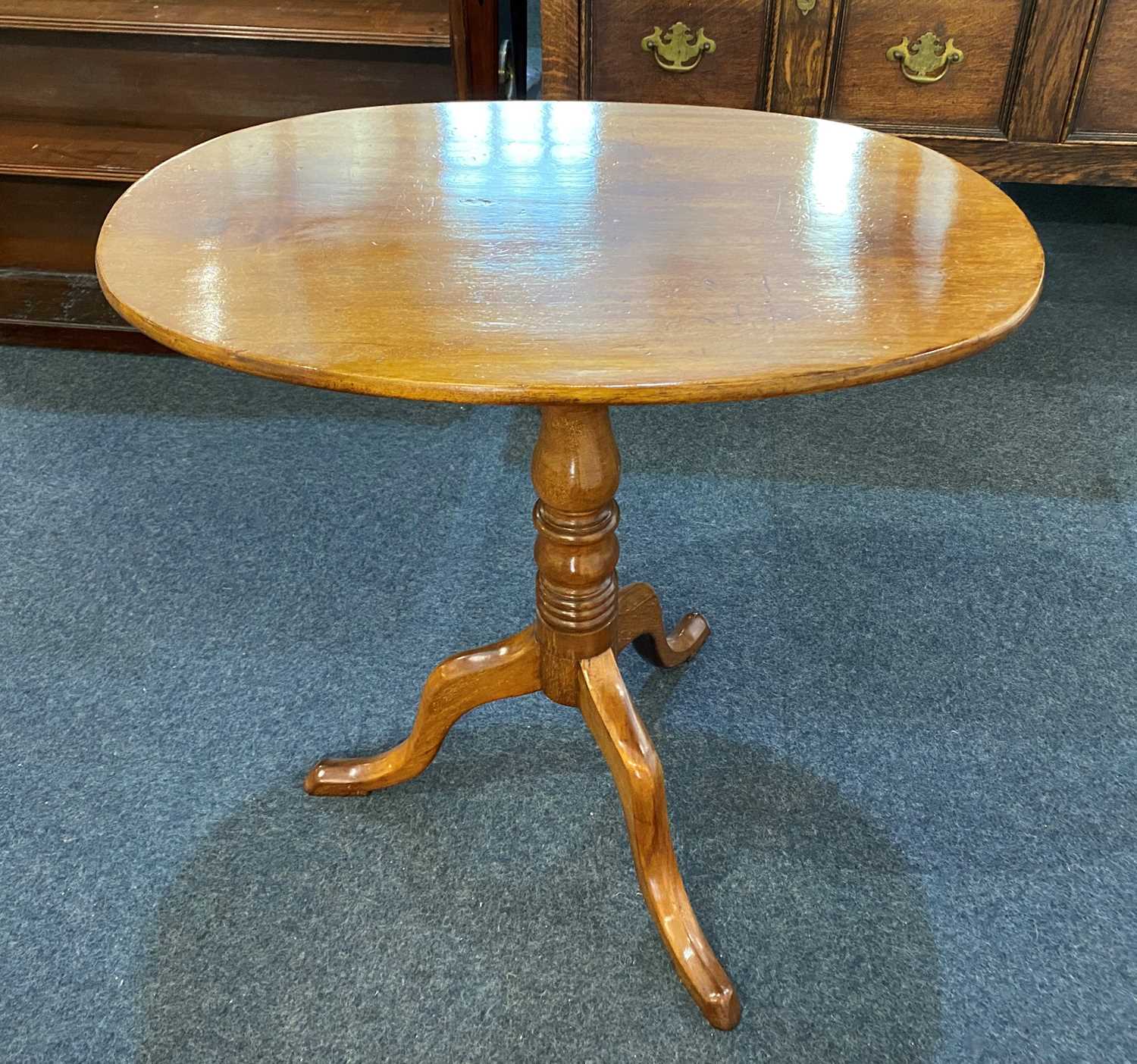 A 19th century mahogany side table, the oval tilt-top on turned column to outswept tripod legs
