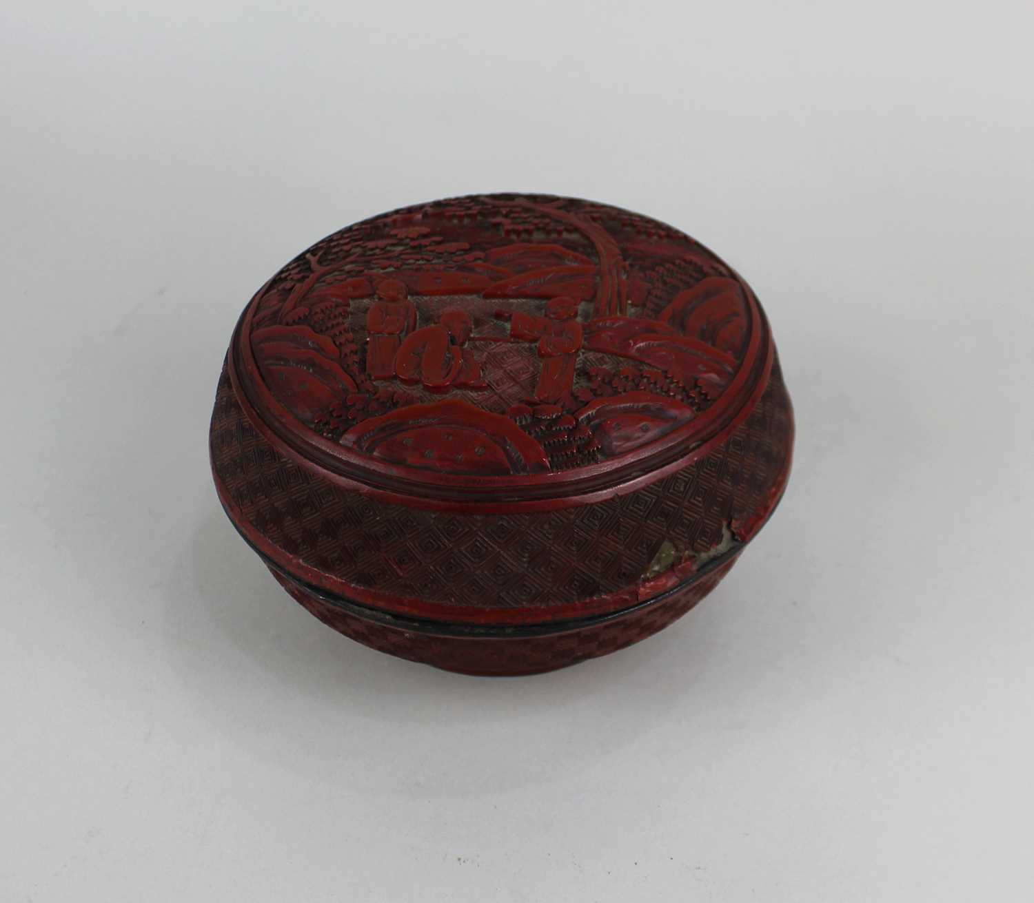 A Chinese cinnabar lacquer box and cover decorated with figures in a landscape 15cm (a/f)
