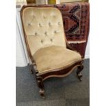 Y A Victorian button upholstered low chair on cabriole legs and castors