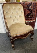 Y A Victorian button upholstered low chair on cabriole legs and castors