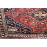 A Persian carpet, pale ground with central pink and blue medallion within multiple borders 168cm