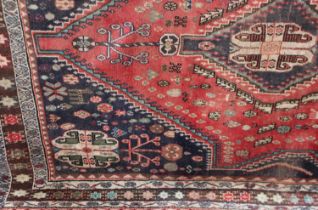 A Persian carpet, pale ground with central pink and blue medallion within multiple borders 168cm