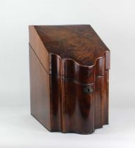 A George III mahogany knife box, of serpentine form, with crossbanded hinged lid, the interior later