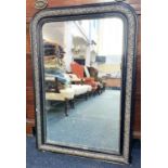 A black and gilt framed rectangular shaped wall mirror, with rounded corners 66cm by 97cm