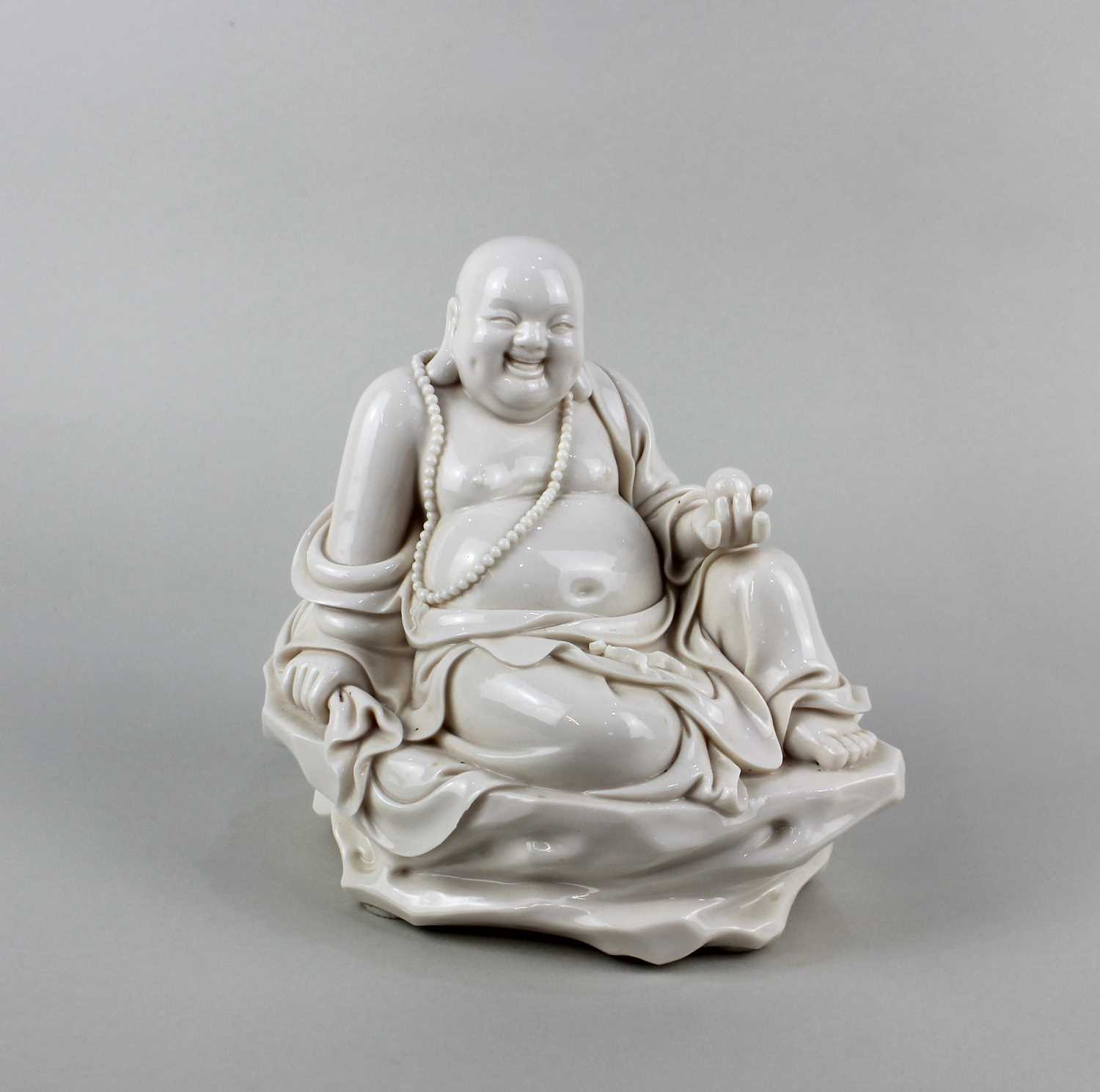 A 20th century Chinese porcelain figure of the Maitreya Buddha, with incised character marks and