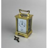 A brass and bevelled glass cased repeater carriage clock the dial marked Samuel Taylor England,