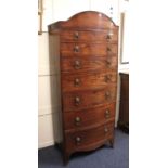 A 19th century mahogany bowfront chest of seven graduated drawers with brass lion mask ring