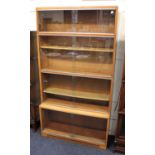 A vintage Minty glazed light oak 4 tier stacking bookcase, each tier with 2 sliding doors, with