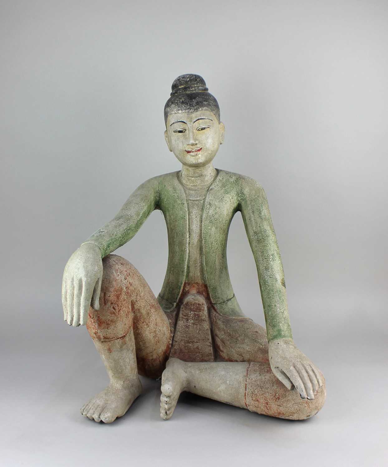 A carved model of a seated Thai style figure 54cm high