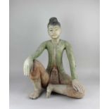 A carved model of a seated Thai style figure 54cm high
