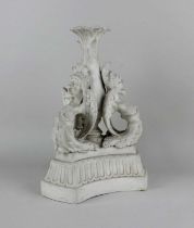 A Parian ware candlestick decorated with winged grotesques 34cm high (a/f)