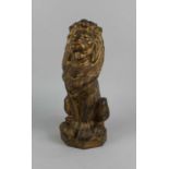 A heavy gold painted metal doorstop in the form of a seated lion 33cm high