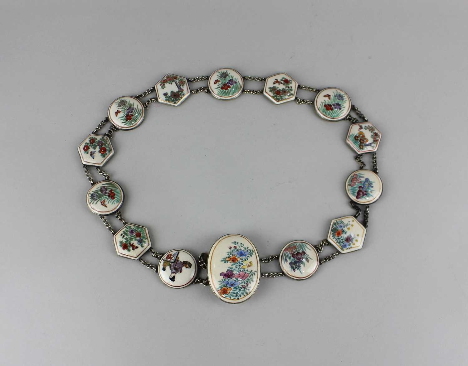 A Satsuma ware belt decorated with figural and floral panels 67cm long