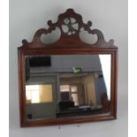 A George III style mahogany fret cut wall mirror with pierced bird surmount mirror plate 29.5cm by