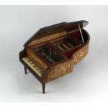 A music box modelled as a concert grand piano with label inscribed 'The Concert Music box of
