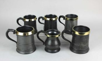Six 19th century brass rimmed pewter tankards, bearing various touch marks, impressed marks, pint