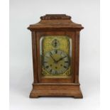 An early 20th century Gustav Becker oak bracket clock with silvered chapter ring. gilt scroll dial