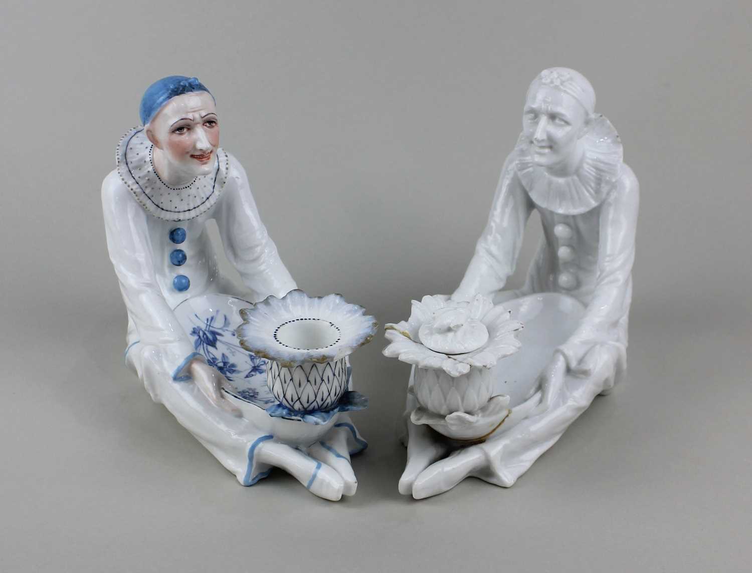 Two Meissen style porcelain dishes in the form of a seated Pierrot, to include one in monochrome