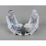 Two Meissen style porcelain dishes in the form of a seated Pierrot, to include one in monochrome