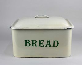 An enamel bread bin with green lettering 'BREAD' on cream ground 16cm high, 32cm wide, 25cm deep