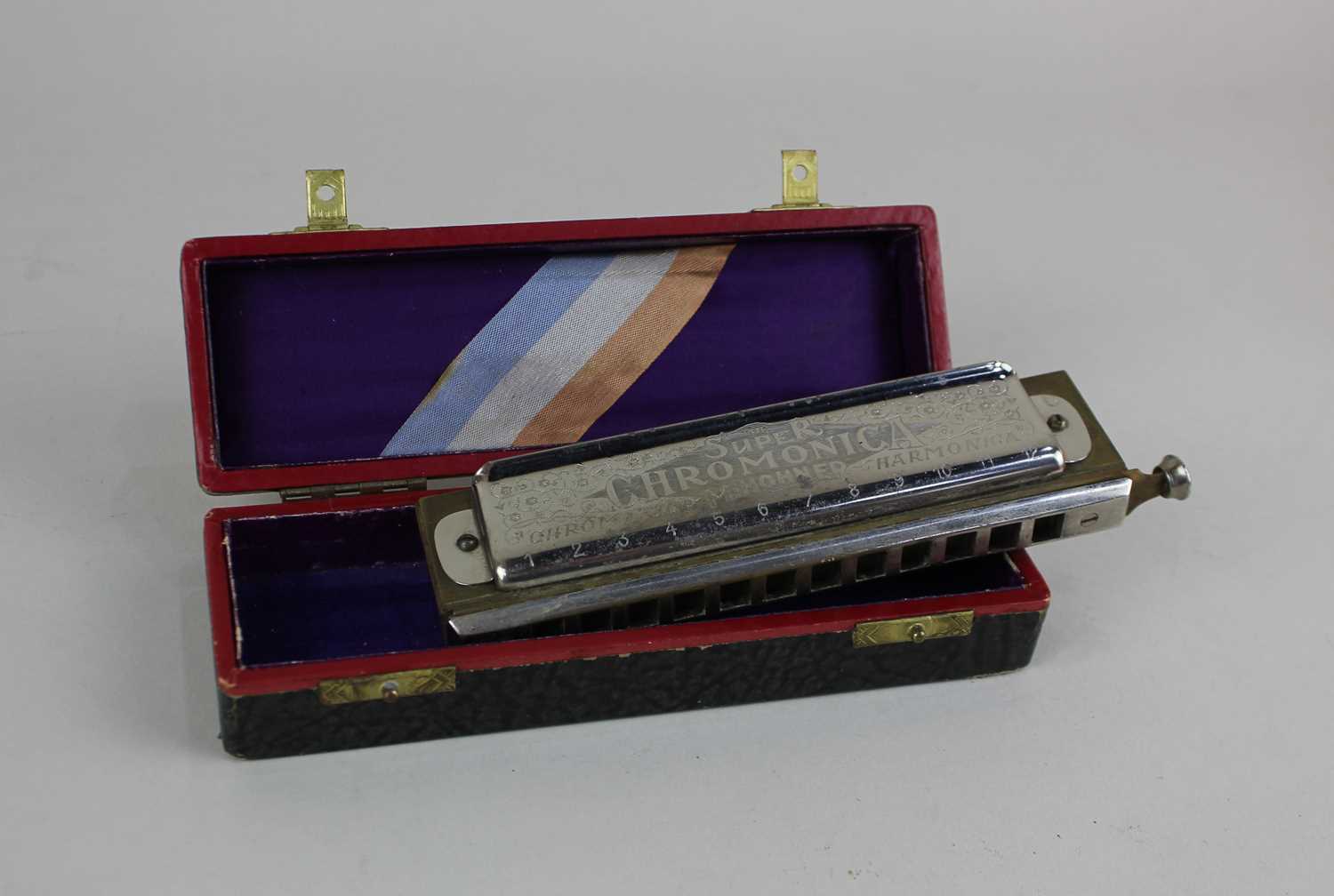 An M Hohner Super Chromonica chromatic harmonica in fitted case