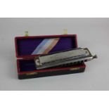 An M Hohner Super Chromonica chromatic harmonica in fitted case