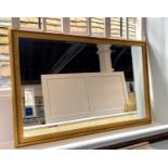 A gilt framed rectangular wall mirror the mirror plate with bevelled edge 64cm by 93cm