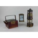 A Protector Lamp & Lighting Co miner's lamp, together with a French brass and bevelled glass cased