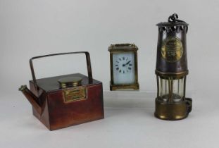 A Protector Lamp & Lighting Co miner's lamp, together with a French brass and bevelled glass cased