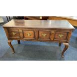 A George III oak dresser with two panelled drawers with brass drop handles, on cabriole legs, 137cm