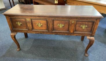 A George III oak dresser with two panelled drawers with brass drop handles, on cabriole legs, 137cm