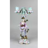 A Meissen porcelain figural three light candelabra modelled as a lady holding an array of fruits