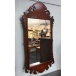 A George III style walnut fret cut wall mirror ht.104cm