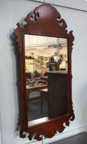 A George III style walnut fret cut wall mirror ht.104cm
