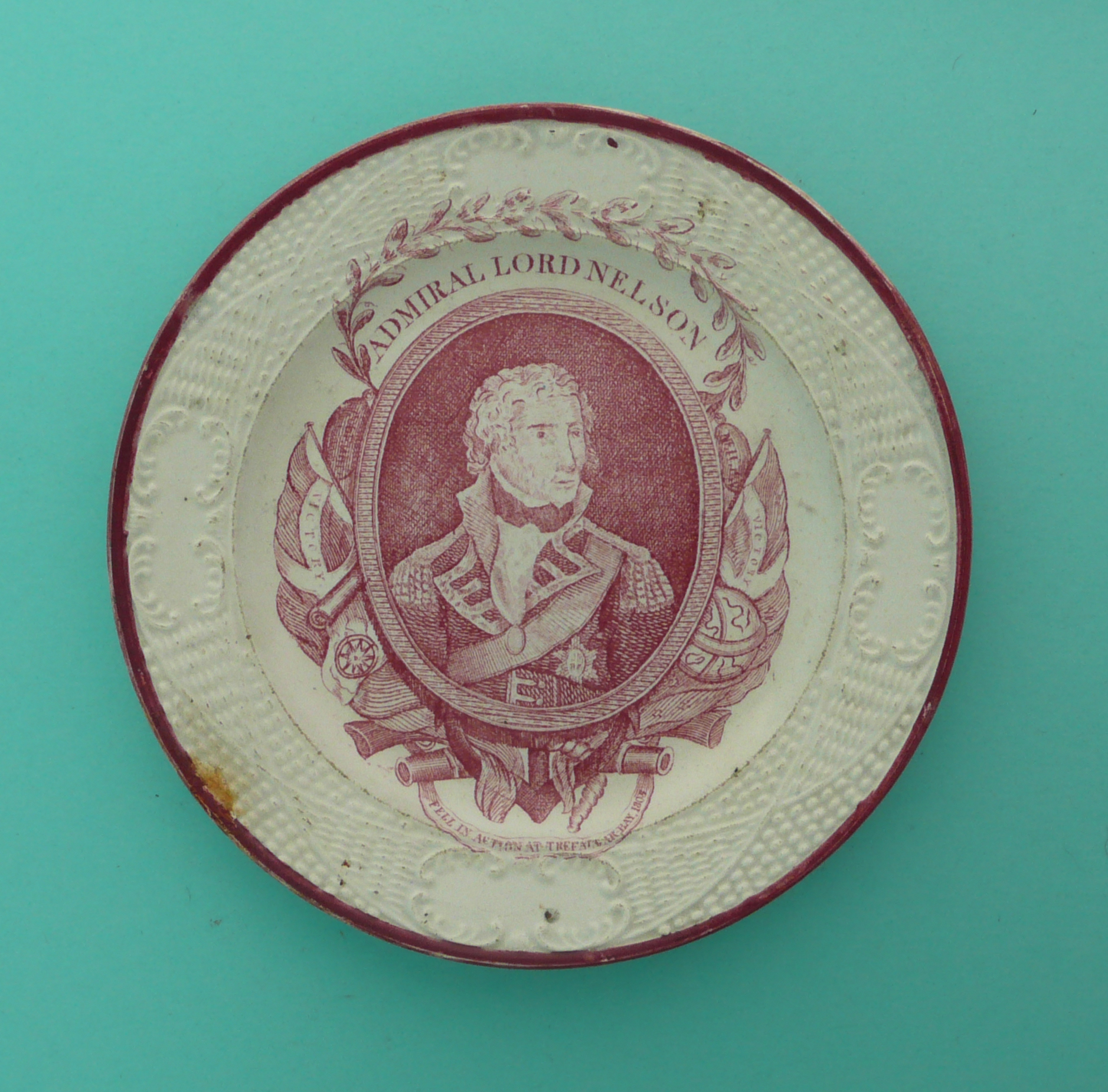 1805 Nelson in Memoriam: an unusual nursery plate with moulded border printed in pink with a named