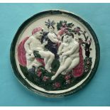 A good Scottish pottery circular plaque moulded with integral border and a scene depicting