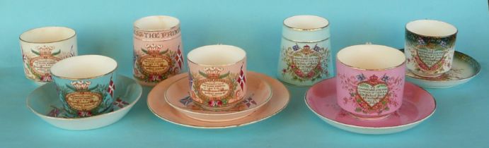 A tapering salmon pink ground mug, a similar trio, a blue ground cup and saucer and another cup