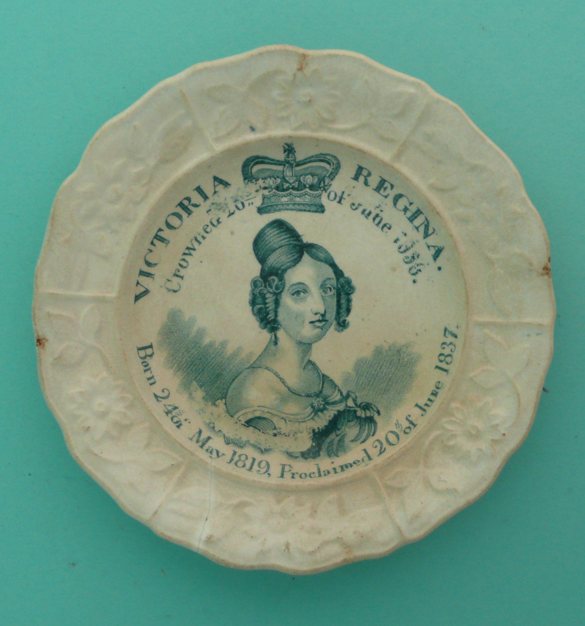 1838 Coronation: a Staffordshire nursery plate the border moulded with flowers and foliage,