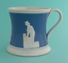 Cricket: a pottery mug the waisted body coloured blue and moulded in white with figures, circa 1850,