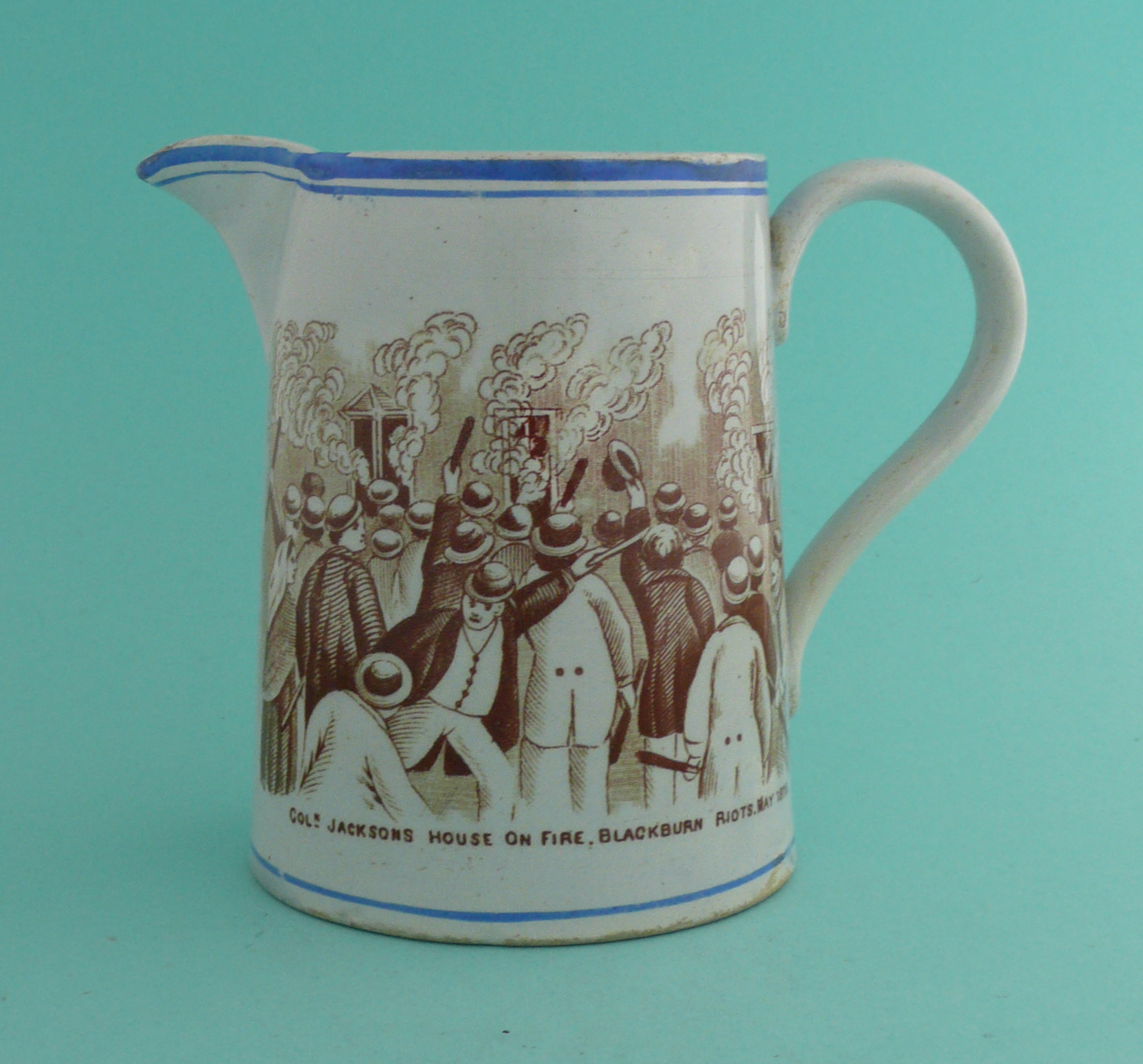 1878 Blackburn Riots: a good and very rare pottery jug lined in blue and printed in brown,