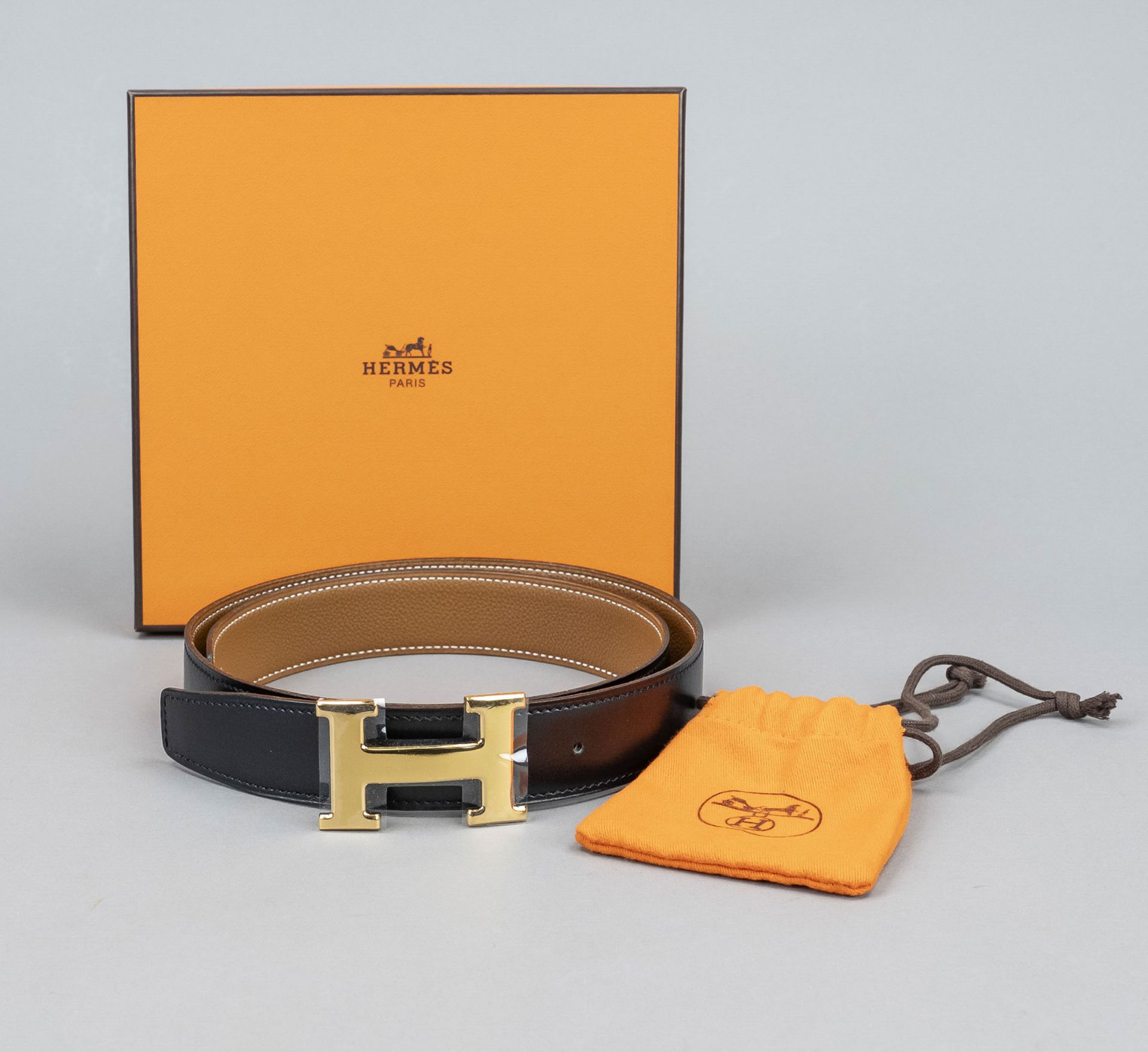 Hermes, reversible belt, soft black and grained cognac-colored leather, partially set off with white