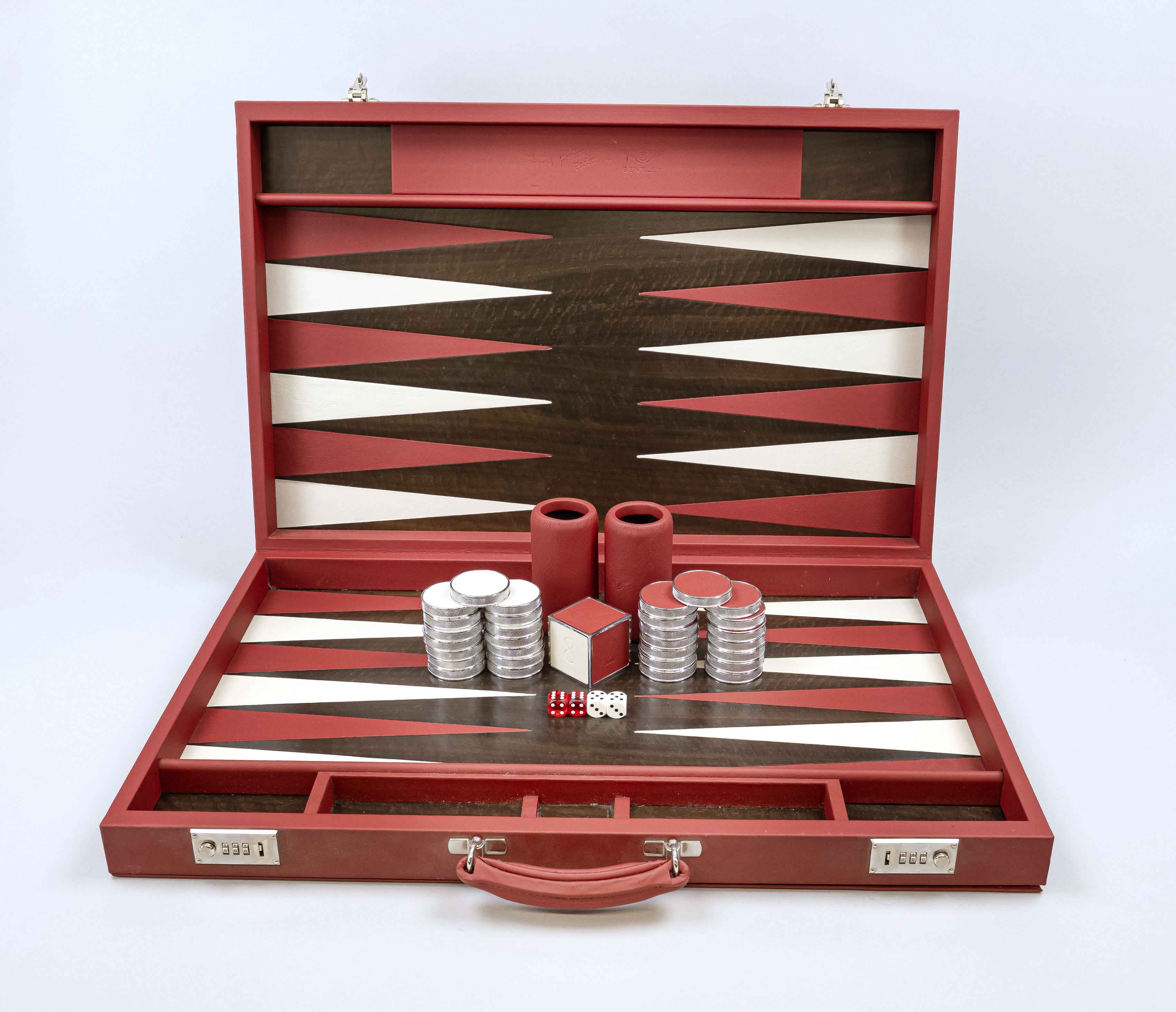 Bentley backgammon, 20th/21st century, red and white leather, red and white chips, dice cup...case