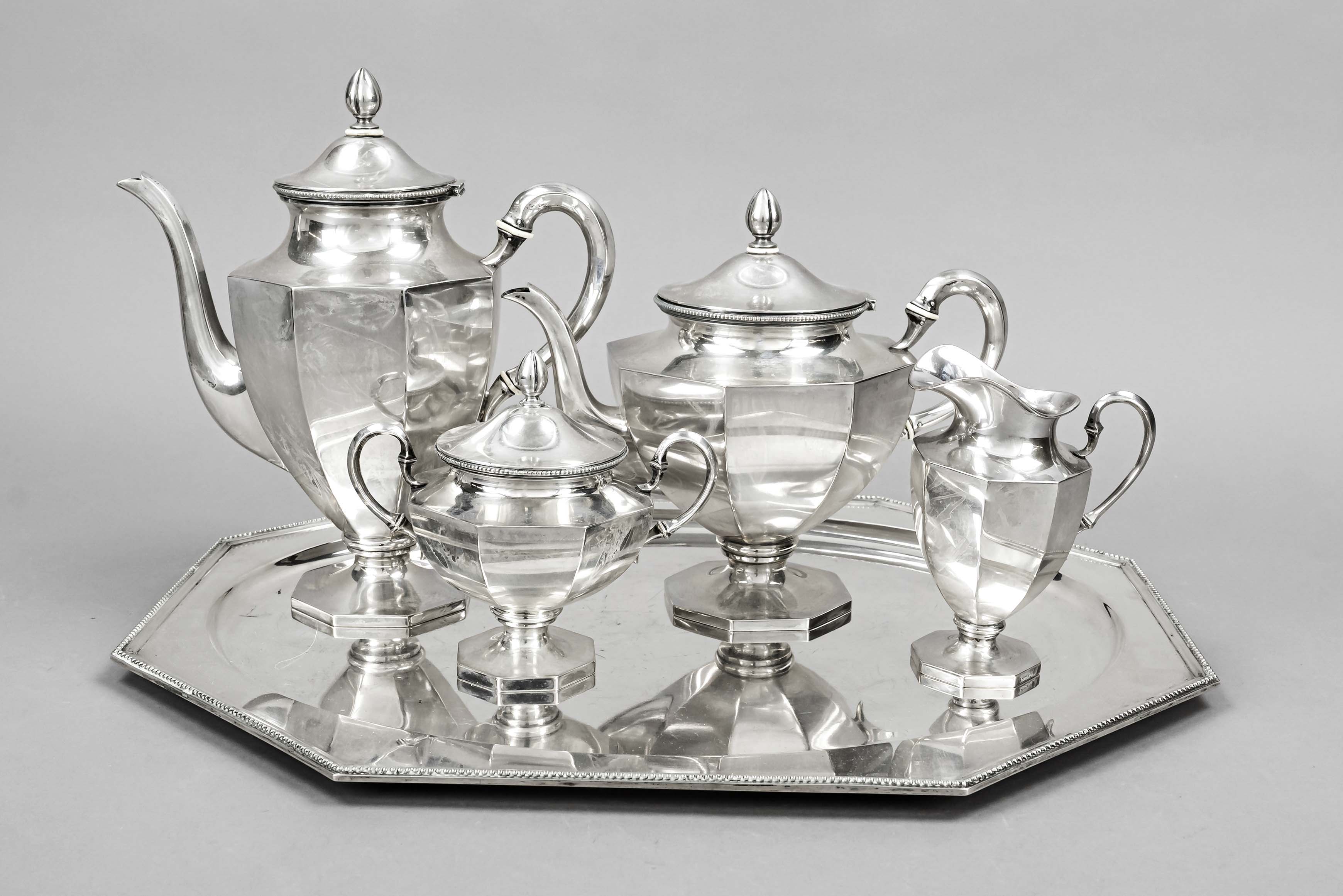 A four-piece Art Deco coffee and tea centerpiece on tray, German, c. 1920, MZ hammered, silver 800/